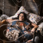 Cecily Strong in a floral patterned bed