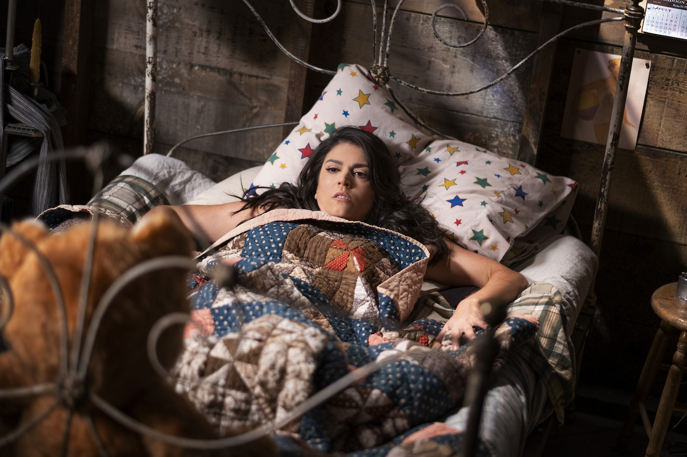 Cecily Strong in a floral patterned bed