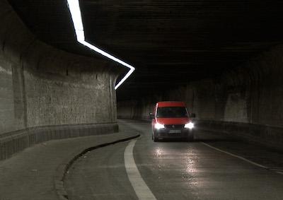 car driving in a dark tunnel