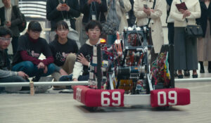 high school students watch the robot they created