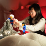 woman working with figurines