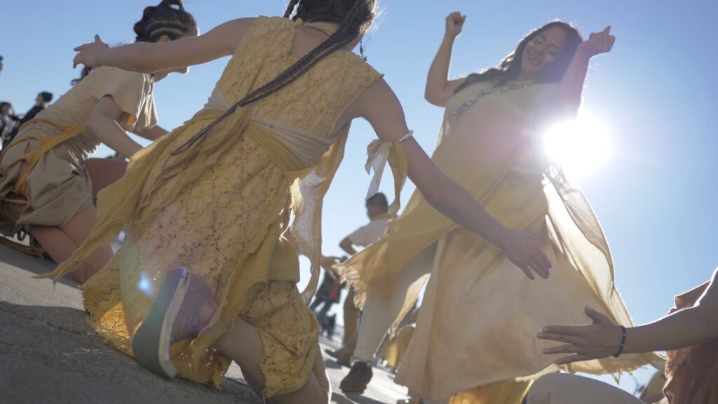 A group of Native American dancers performing in a circle.