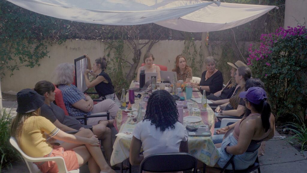 Group of woman seated around a table outdoors