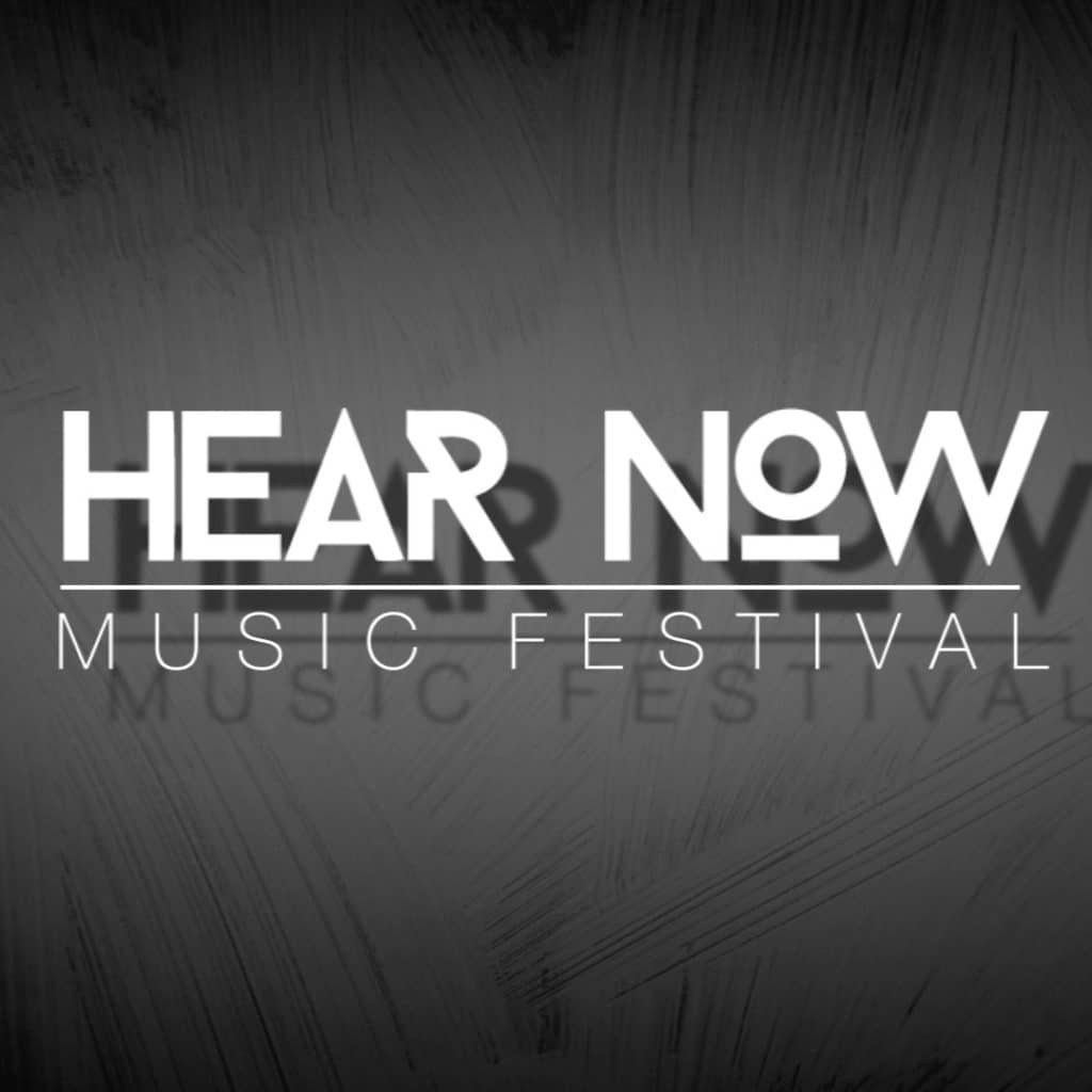 Textured slate gray square with white shadowed text 'Hear Now Music Festival'
