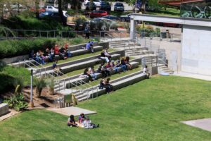 About two dozen people sit on the terraced seats of the outdoor amphitheater The Wild Beast at CalArts.