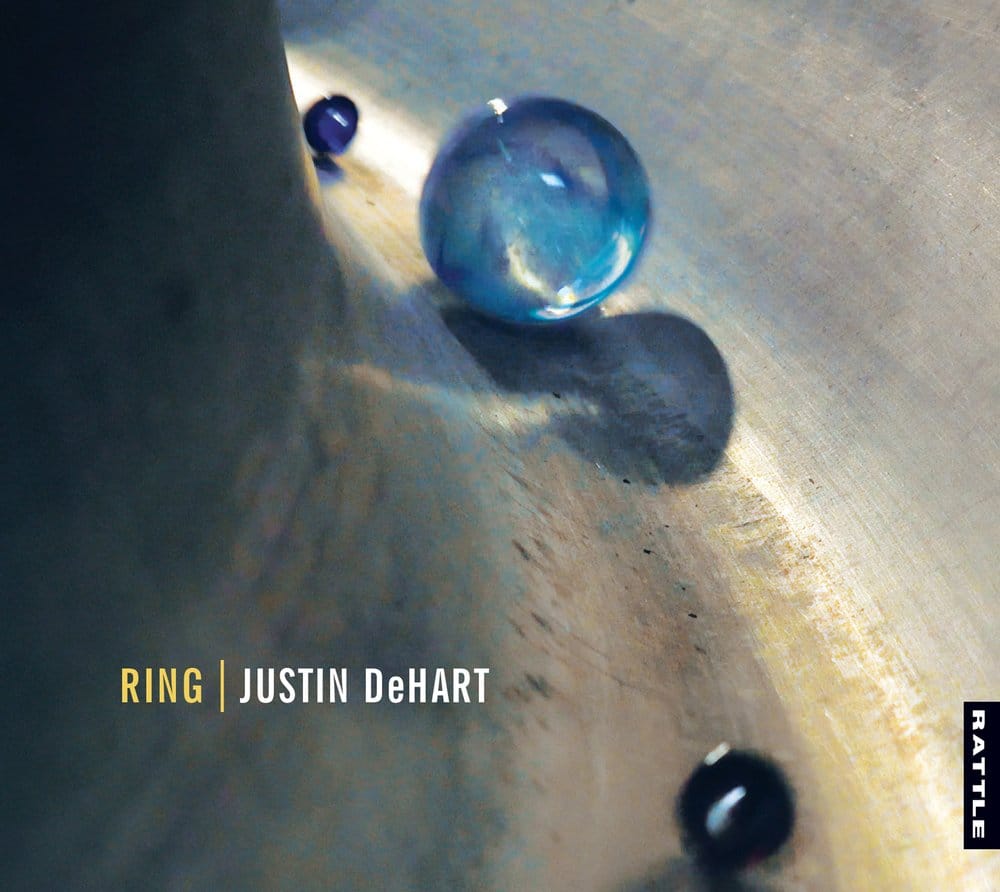 Album cover of Justin DeHart's Ring album featuring three marbles of different sizes in a metal musical instrument.