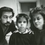 A man with a beard, a child in the middle and a woman in a close image in a still from 'No Supper.'