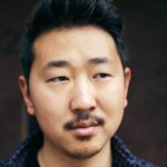 Portrait of Andrew Ahn against dark background
