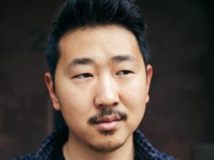 Portrait of Andrew Ahn against dark background