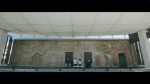 Six people face "America Tropical" by David Alfaro Siqueiros in this still image from ARTBOUND Season 14.