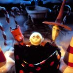 Film still of three Halloween Town children holding up a large sack at a Christmas-themed front entrance