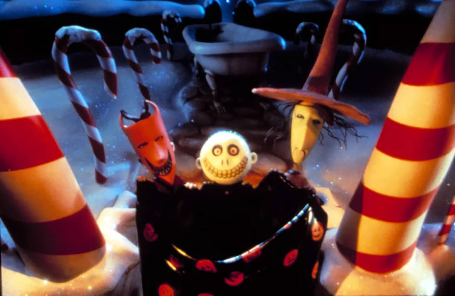 Film still of three Halloween Town children holding up a large sack at a Christmas-themed front entrance