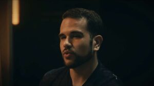 Michael Echaniz in dark shirt against dark background