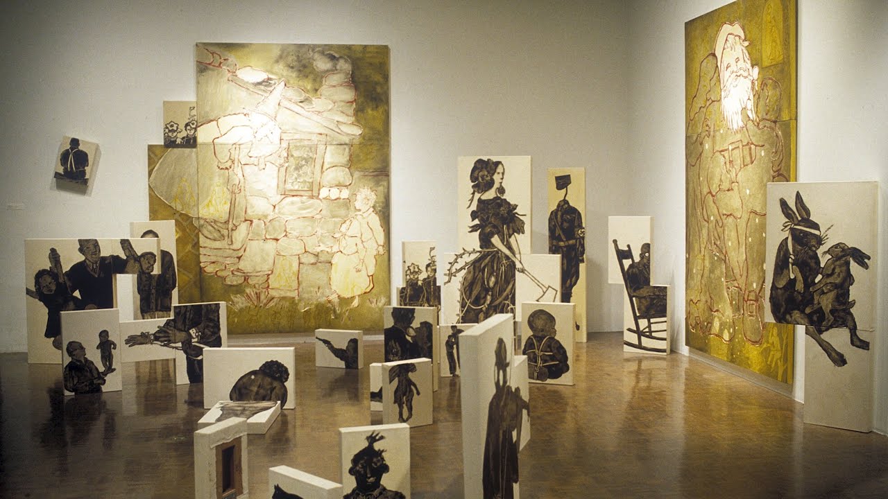 Gallery view of assembly of canvas paintings of different sizes on wall and floor