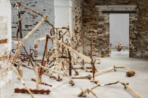 Gallery view of a series of sculptures made of joined hand-carved wooden spindles