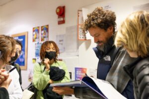 Bob Persichetti signs books for attendees at CalArts.