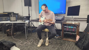 Marcos Mena playing electric guitar