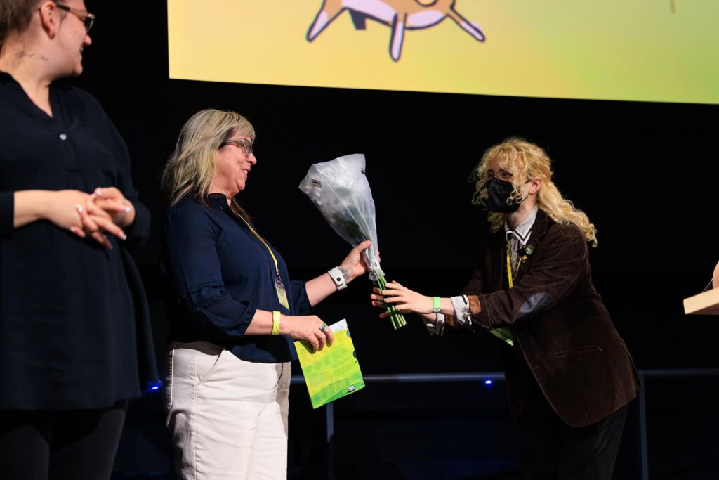 Student hands bouquet of flowers to Abigail Severance on Geffen Theater stage.