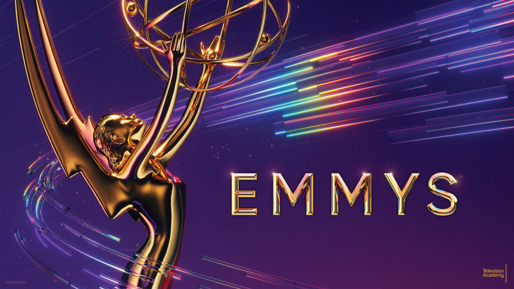 Closeup of Emmy Awards trophy against purple background and and rainbow streaks