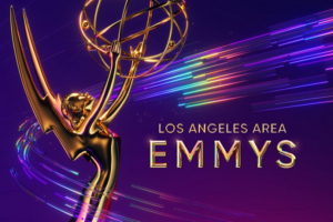 Purple graphic for LA Area Emmys with closeup of golden Emmy Award figure holding rings in a sphere.