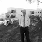 Bob Fitzpatrick in a white shirt and tie stands in front of Ahmanson Hall in 1986.