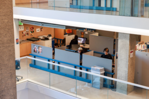 Wide view of one story of the A-Block with students working at cubicles.