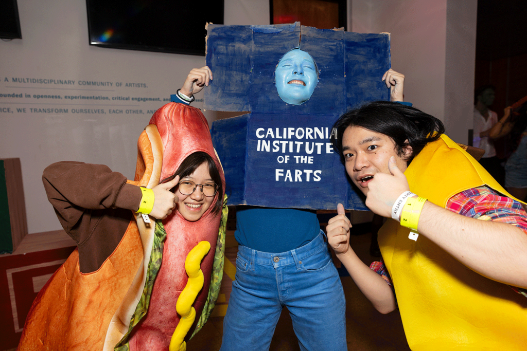 Three students dressed as a hotdog, banana, and the Blue Wall posing