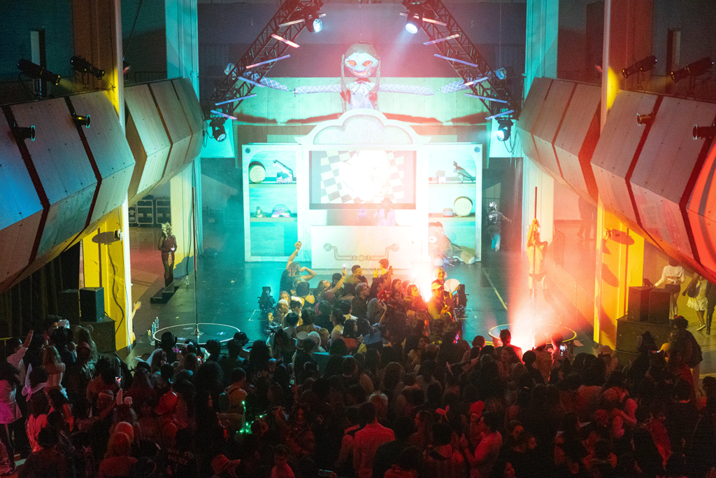 Overhead view of students dancing in moodily lit Main Gallery