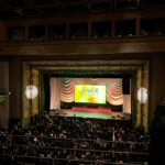 Balcony view of Royce Hall with Annie Awards logo splashed on large screen on stage