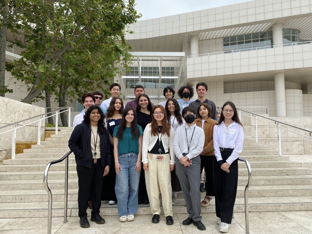 Group shot of 16 students standing at the steps leading to North Pavilion at the Getty Museum