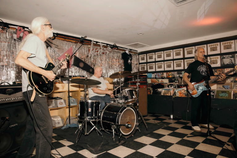 Suburban John performing in space with checkerboard floor