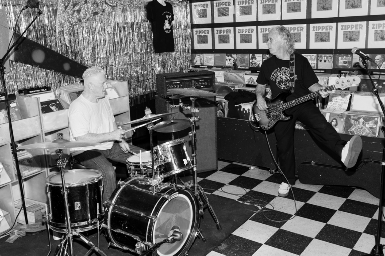 Black and white image of drummer and bassist