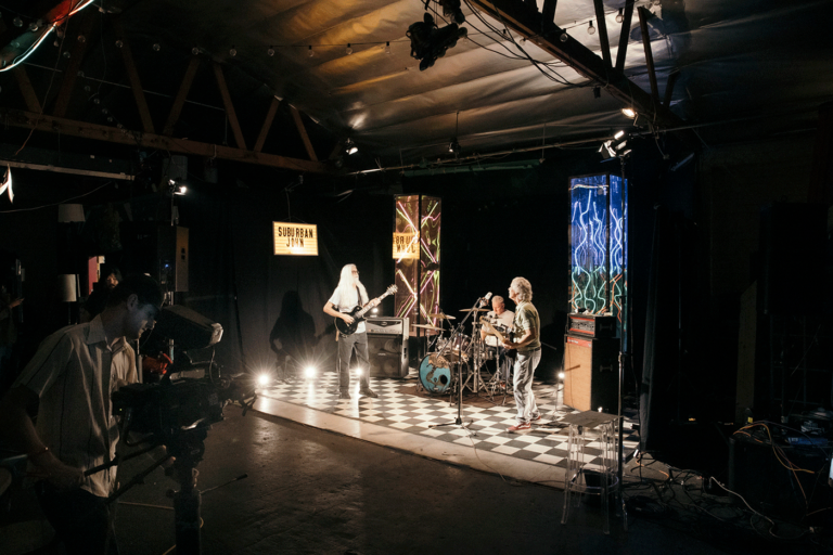 Band being filmed while performing on TV stage