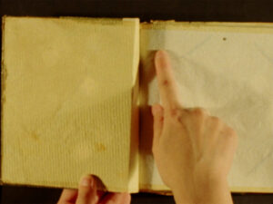 A finger points in a journal