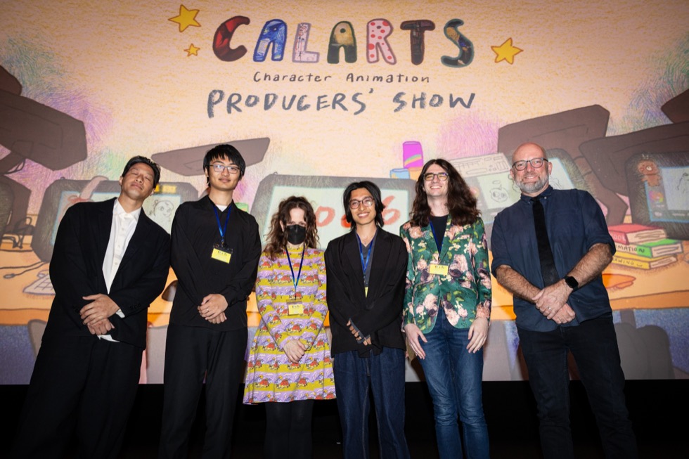 A group of people standing in front of a screen that reads, 'CalArts Character Animation Producers' Show.'