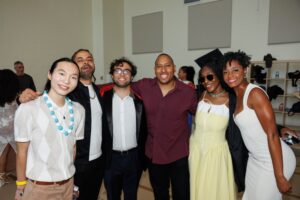 A group of CalArts graduates pose for the camera before the 2026 graduation.