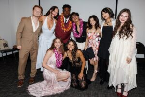 A group of CalArts grads pose for a picture before graduation.