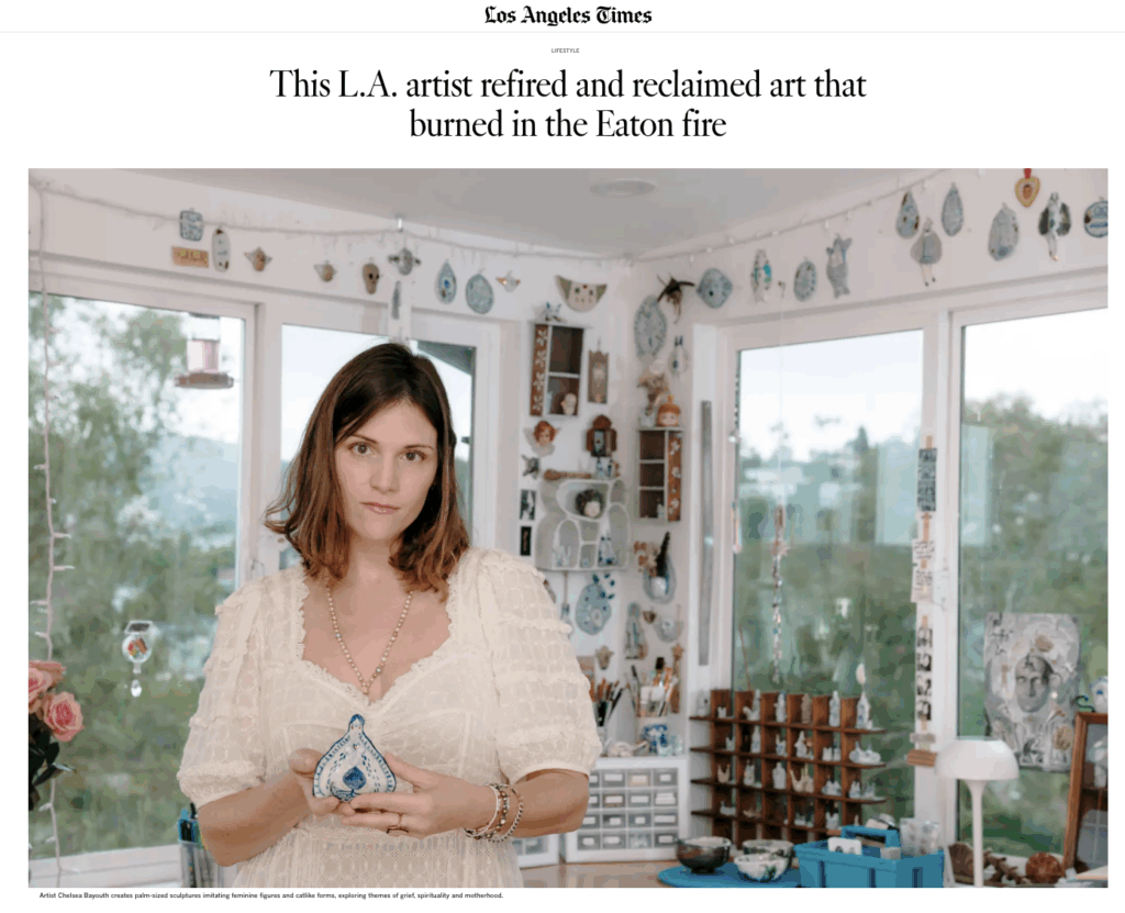 Artist Chelsea Byers stands in her studio, holding a blue and white ceramic piece, surrounded by various art pieces and decor.
