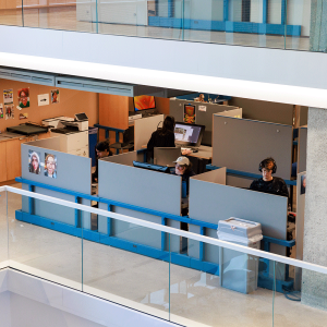 Wide view of one story of the A-Block with students working at cubicles.