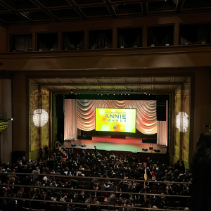 Balcony view of Royce Hall with Annie Awards logo splashed on large screen on stage