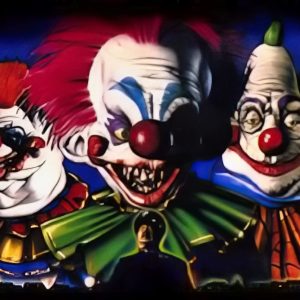 Five grotesque clowns with exaggerated, colorful features set against a blue background.