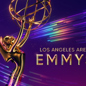 Purple graphic for LA Area Emmys with closeup of golden Emmy Award figure holding rings in a sphere.