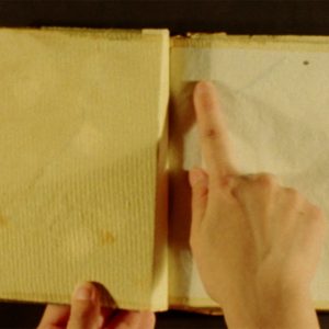 A finger points in a journal
